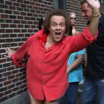 photo of Richard Simmons wearing a red shirt with (seemingly) no pants.